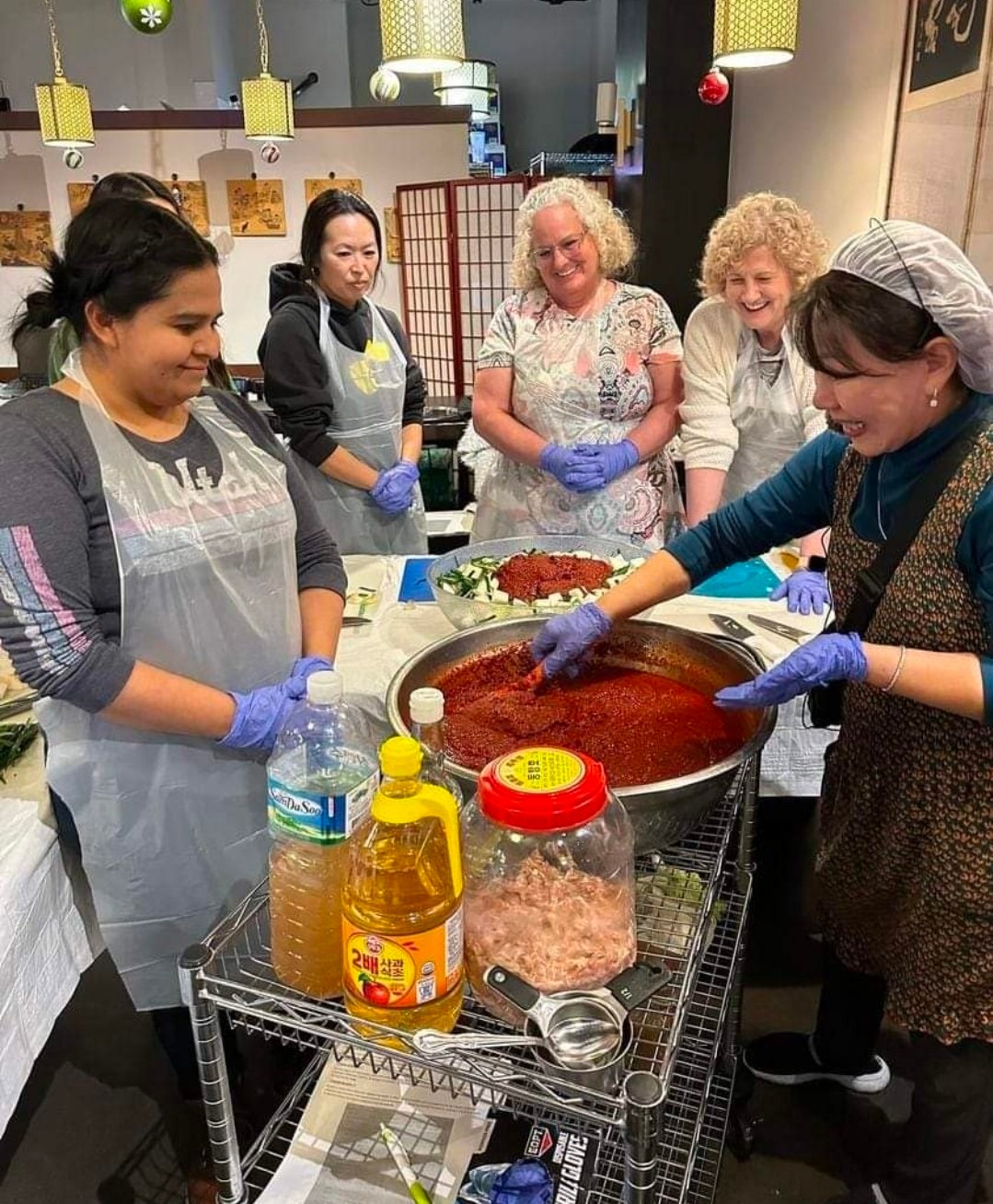 Mom teaching a hands-on kimchi-making class at Yummy's Korean BBQ