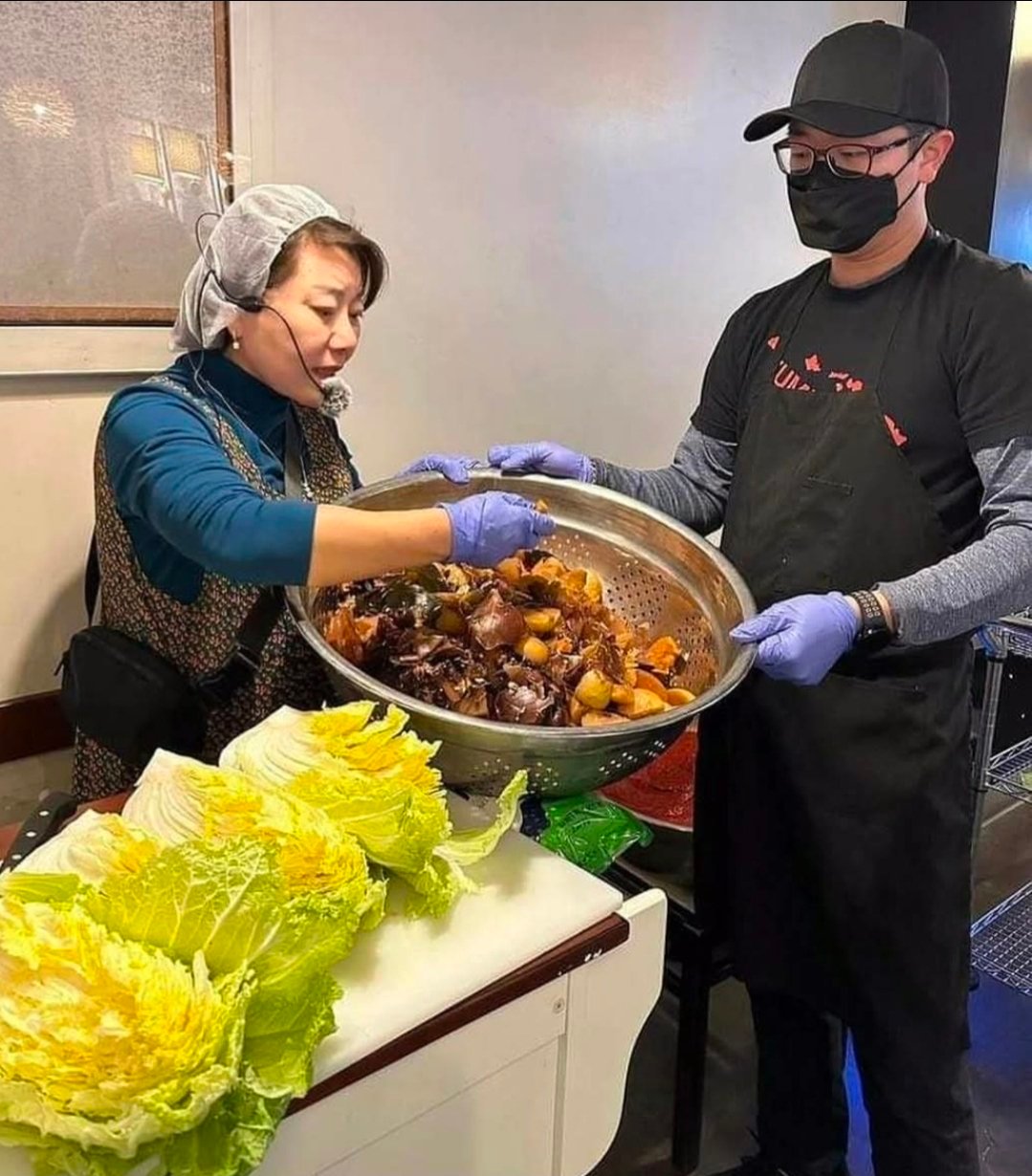 Sun and his mom making kimchi by hand at Yummy's Korean BBQ